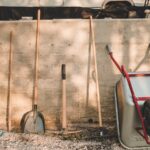 red and black shovel beside brown wooden stick